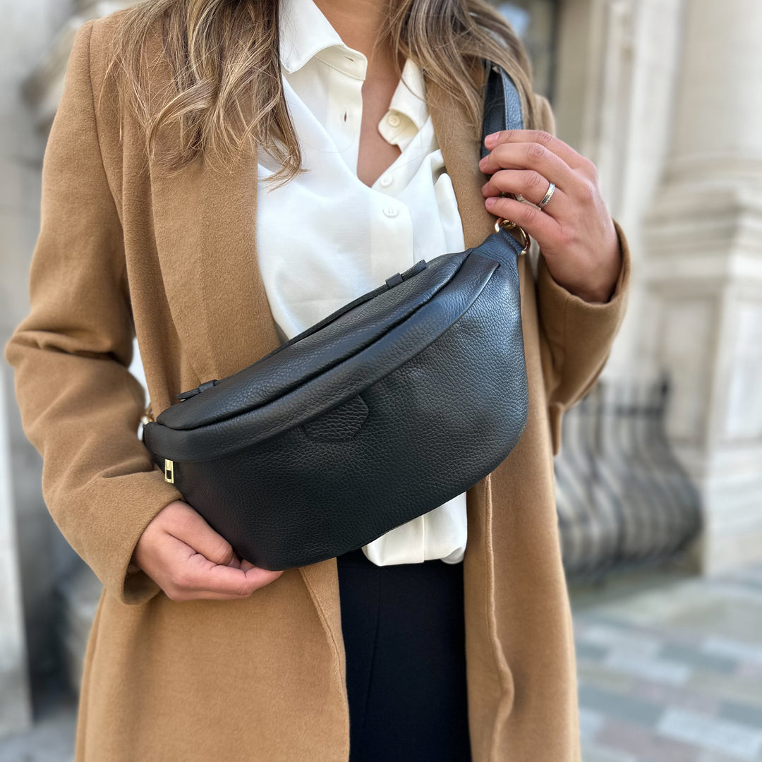 Lady wearing a black leather bumbag 