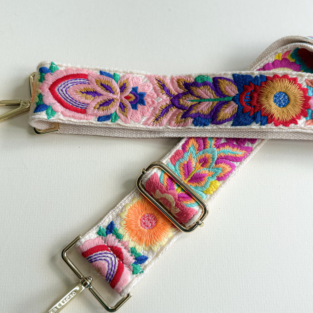 Colorful embroidered strap with floral patterns on a white background