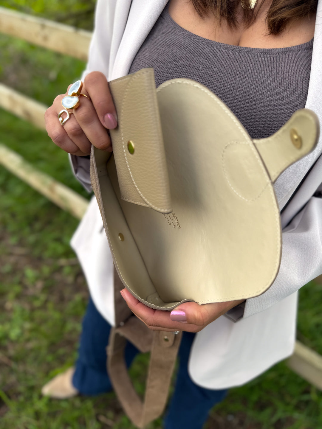 Inside Arabella latte suede crossbody bag showing space for phone, cards and essentials