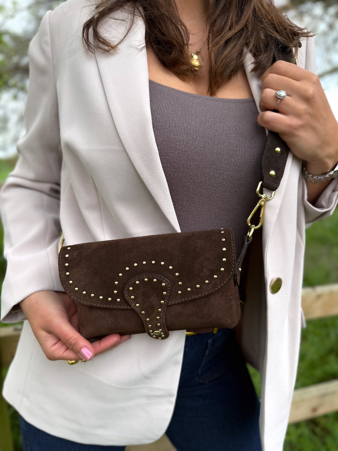 Close-up of soft Italian suede leather and gold studs on Arabella crossbody bag dark brown 