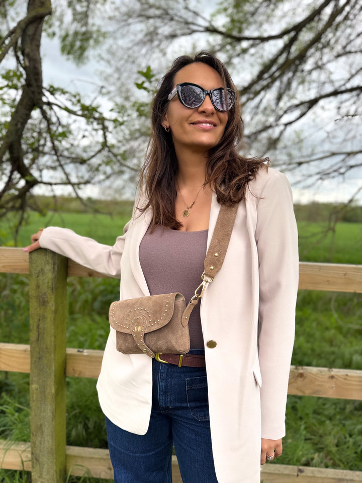 Arabella suede crossbody bag side view with statement gold stud detailing latte 